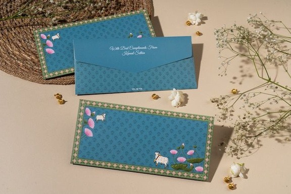 Forest green cash envelope featuring traditional Indian Pichwai cow art and gold arches