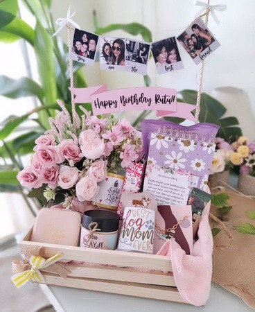 Curated wooden birthday gift hamper containing customized floral diaries, cards and flowers by Keya Meghani