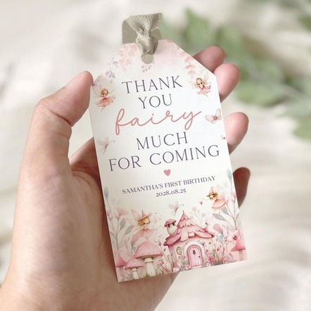 Handmade diamond-shaped floral thank you tag tied with rustic twine on linen background by Keya Meghani